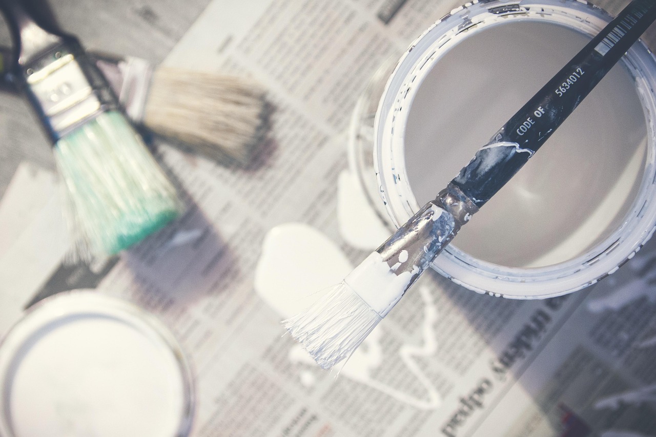 Painter preparing brushes and paint for an interior decorating job